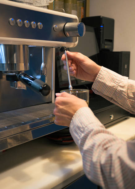 istock Close-up of a waiter at a coffee machine 1443527514