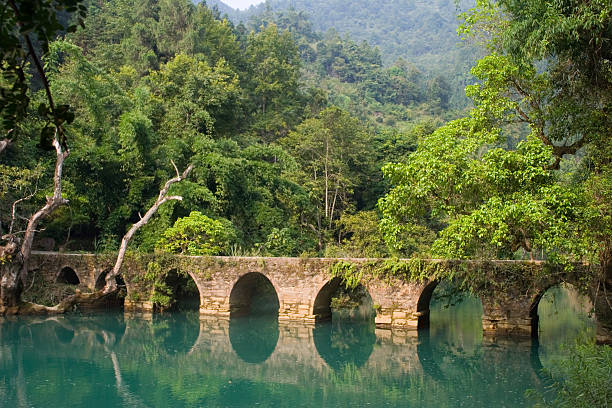istock Xiaoqikong Bridge across tranquil river 144352957