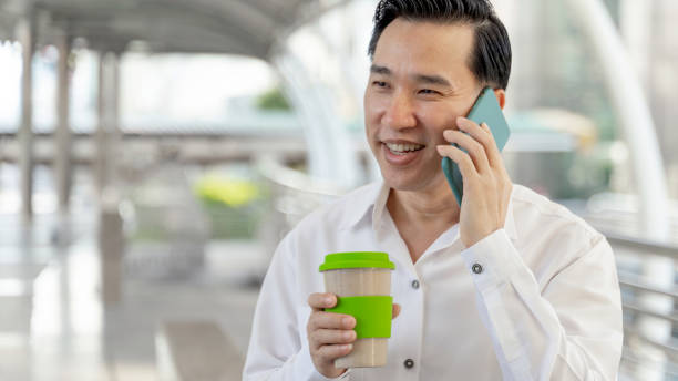 istock Successful asian business man using smart phone and coffee cup in hand , business concept 1443529657
