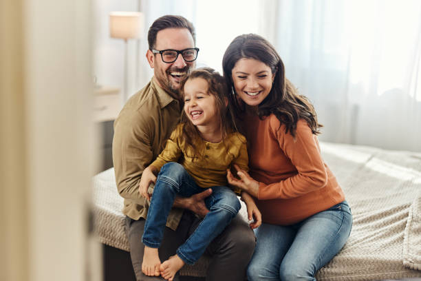 istock Young cheerful family having fun in bedroom. 1443530956
