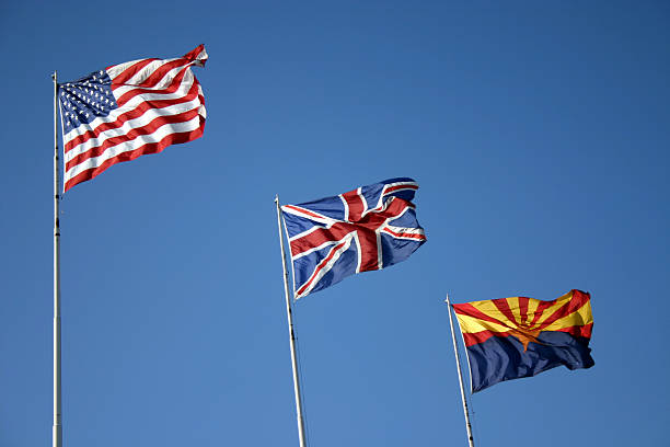 Three flags fly in the wind stock photo