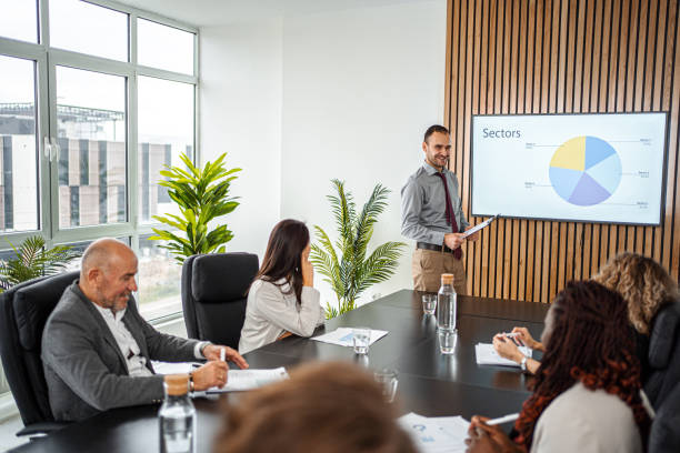 istock Businessman Leads Business Meeting with  Statistics Presentation 1443531329