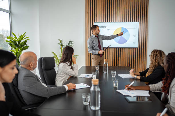 istock Businessman Leads Business Meeting with  Statistics Presentation 1443531624