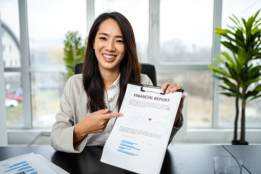 Portrait of a businesswoman showing document