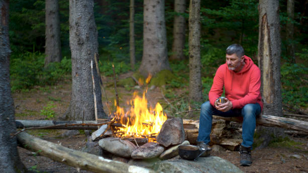 istock Bearded man near a fire in the mountains 1443533495