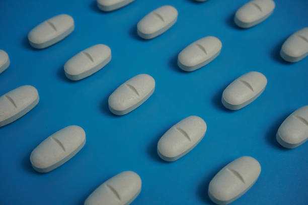 istock pattern made with Pharmaceutical medicine pills, tablets and capsules on blue background. 1443534645