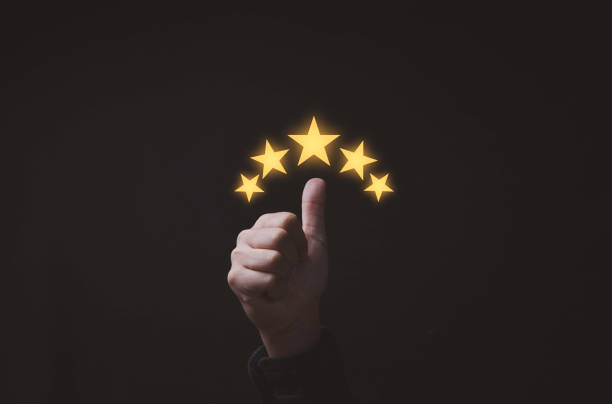 istock Thumb up with glowing yellow five stars for excellent evaluate after customer use product service , ISO and quality standard certificate concept. 1443534673