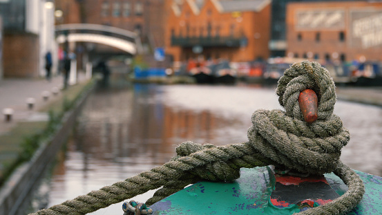 Close up of the rope securing the bow of a barge moored at Gas Street Basin in the city centre of Birmingham, England.