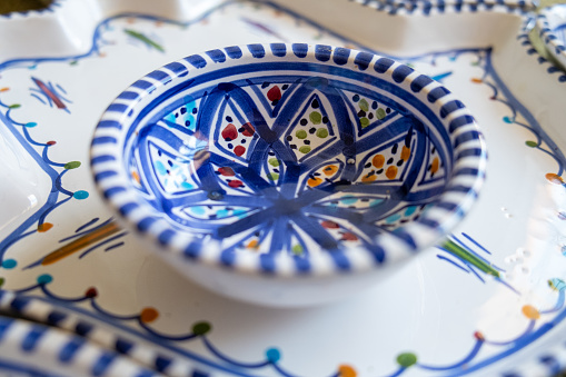 Colorful clay ceramic cups on gray background close up