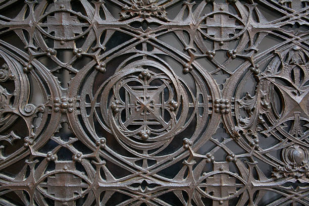 Decorative Ironwork Old antique detailing of some decorative ironwork used in front of a glass panel. art nouveau ironwork stock pictures, royalty-free photos & images