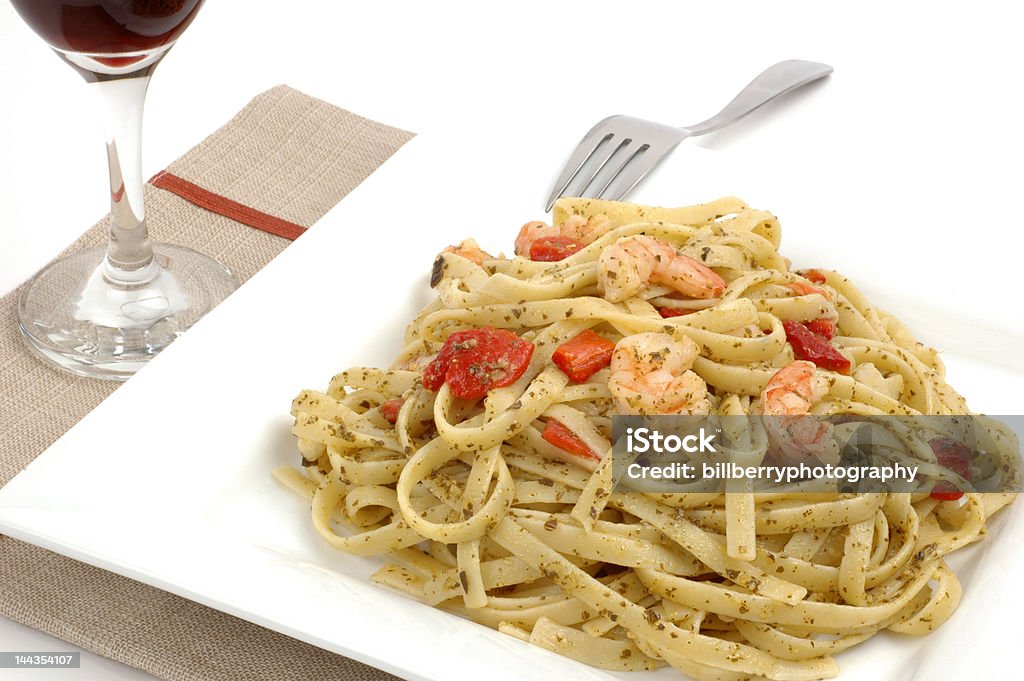 Fettuccine and Shrimp Fettuccine with pesto roasted peppers and shrimp. Dinner Stock Photo
