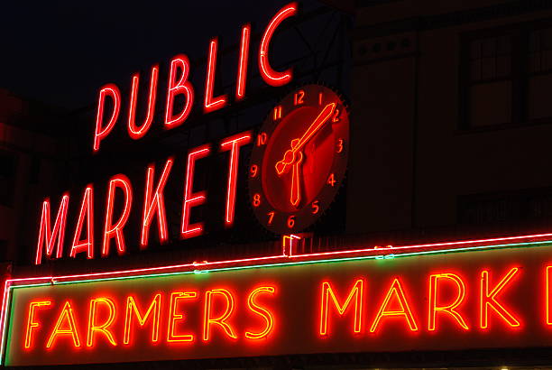 Neon Market Sign and Clock stock photo