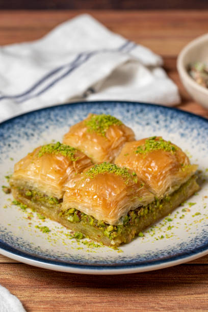 Pistachio baklava on wooden background. Turkish cuisine delicacies. Turkish baklava. close up stock photo
