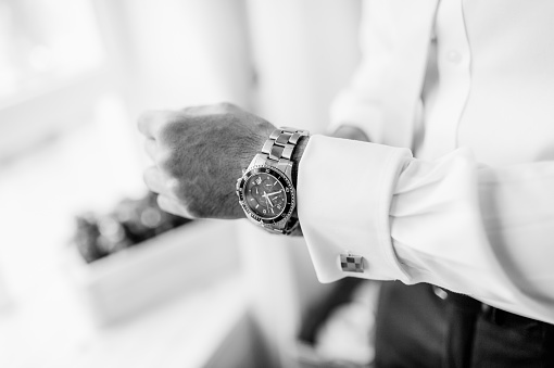Elegant designer watch on handsome man hand. Modern stylish watch on a wrist.
