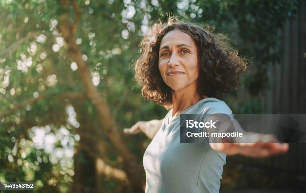 Smiling Mature Woman Doing Yoga Outside In A Park In Summer Stock Photo - Download Image Now
