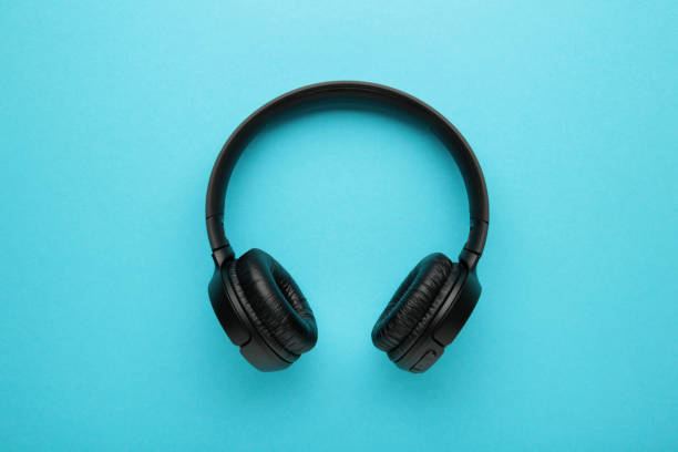 istock Black, modern wireless headphones on a blue background. 1443544029