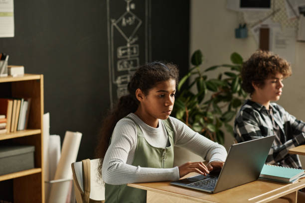 istock Girl using laptop at lesson in classroom 1443546198