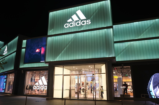 Beijing,China-Sep. 13th 2022: large adidas flagship retail store at night.