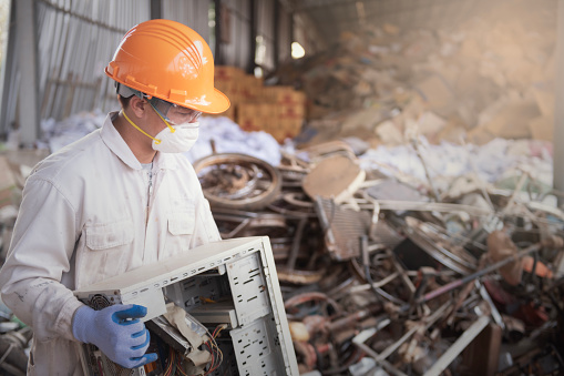 Worker in recycling industry plant Electronic waste management of worker in the uniform.
