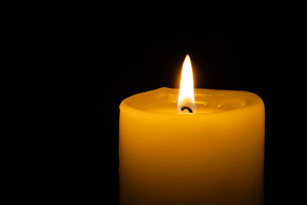 istock a burning candle on the black backgrounds 1443549134