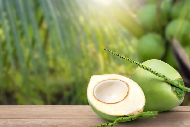 istock Young green coconut with half sliced on wooden table 1443549473