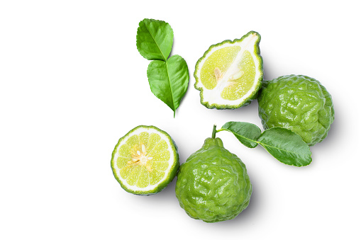 Bergamot fruit with seeds and green leaf isolated on white background. Top view. Flat lay.