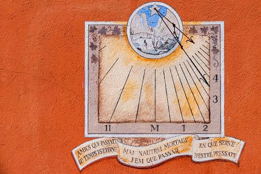 sundial on the wall of a house at Moustiers-Sainte-Marie in the Provence region. It considered as one of the most beautiful villages of France; Moustiers, France