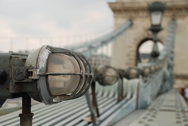Close-up of the lighting fixed on the actual chain of the bridge.