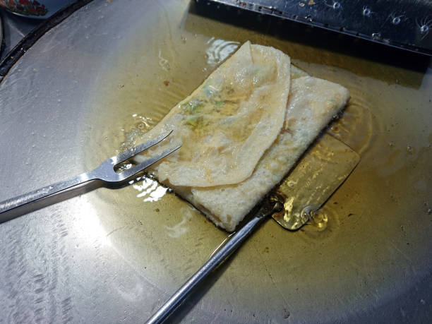 istock Martabak Telor. Savoury pan-fried pastry stuffed with egg, meat and spices, the cooking process. 1443550725