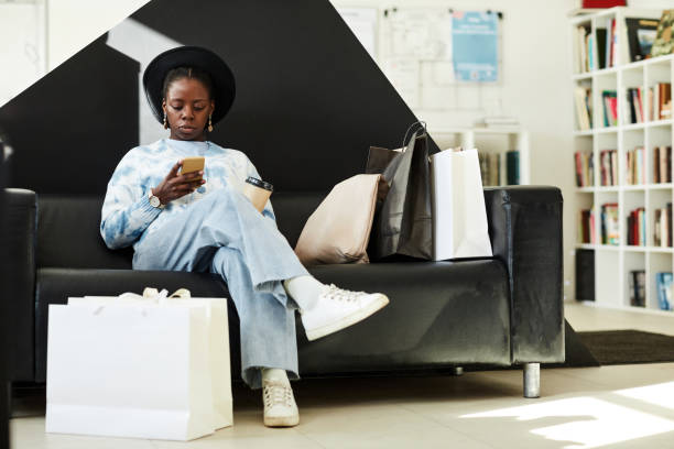 istock Young black woman relaxing at thrift store 1443552160