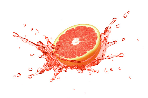 Red grapefruit juice splash isolated on white background.