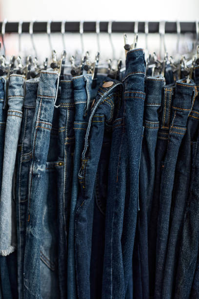 istock Blue denim jeans in row on clothing rack 1443552455