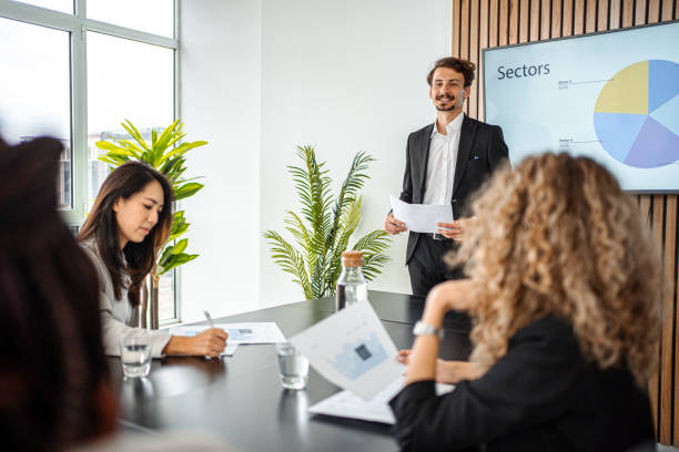 istock Businessman Leads Business Meeting with  Statistics Presentation 1443554337