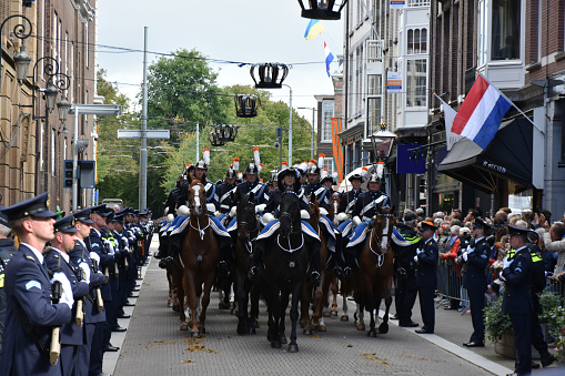 Dutch Armed Forces Standing With Gun, Riding With Horse, Looking, Escorting Dutch Royal Family Back To Noordeinde Palace, People Standing, Looking Around, Taking Picture And Greeting Dutch Royal Family Who Is Sitting Down Inside Glass Coach During Prinsjesdag, The Day On Which King Willem Alexander Of The Netherlands Addresses A Joint Session Of The Dutch Senate And House Of Representatives To Give The Speech From The Throne Setting Out The Main Features Of Government Policy For The Coming Parliamentary Session In The Hague The Netherlands Europe