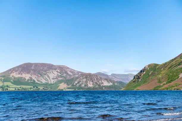 Wast Water or Wastwater is a lake located in Wasdale, a valley in the western part of the Lake District National Park, England, UK, beautiful summer day and blue cloudy sky