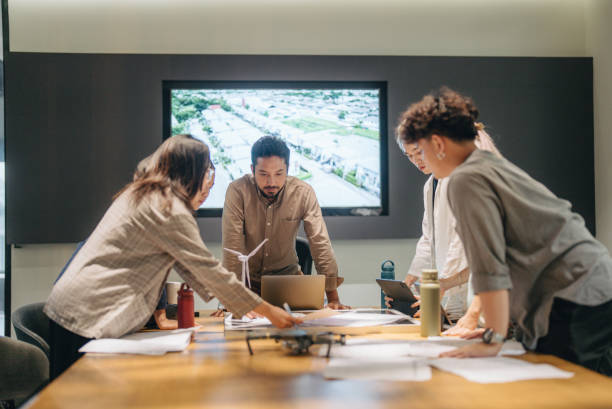 istock Business people discussing documents and ideas at meeting. 1443558623
