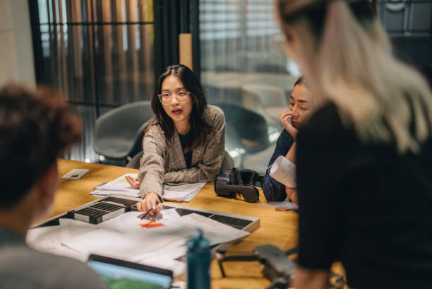 istock Asian woman presenting a wind turbine project. 1443559213