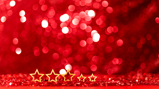 Christmas stars on shiny red background.