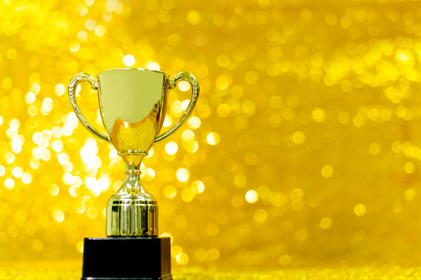 istock Golden trophy on shiny background 1443561704