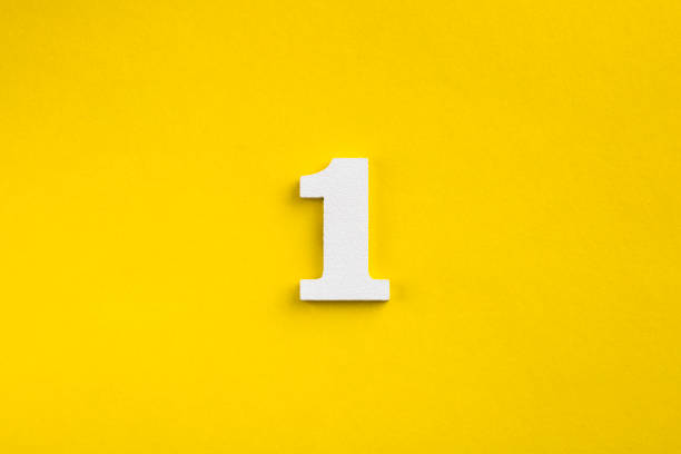 istock Number one - white number in wood on yellow background 1443563625