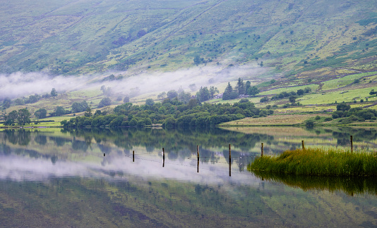 Mist over the Llyn Cwellyn Lake at Sunrise in Snowdonia National Park, North Wales, United Kingdom