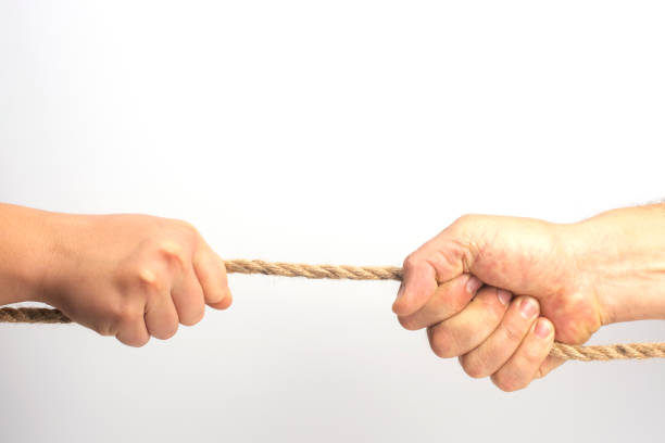 istock The concept of help and mutual assistance. A person pulls another person out of problems. 1443566714
