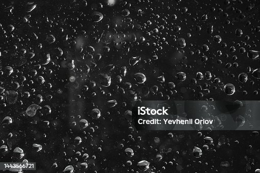 istock Drops of water on glass on a black background. 1443566721