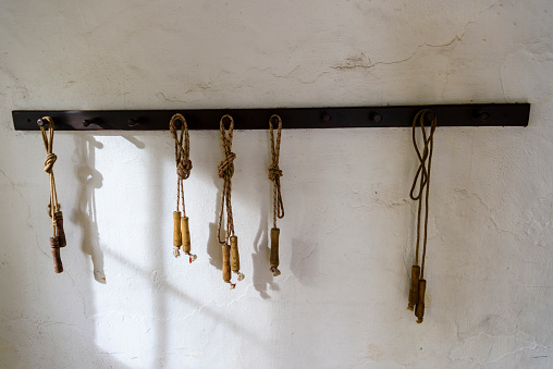 Old fashioned skipping ropes hanging from pegs in the entrance of an old Irish schoolhouse