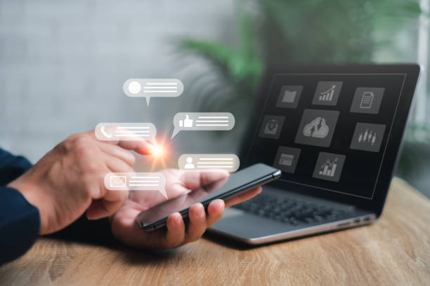 istock Businessman use smartphone to communicate with customers through chat and laptops working on tables, diagrams virtual screen of business workflow Online documentation database and digital file system 1443566977