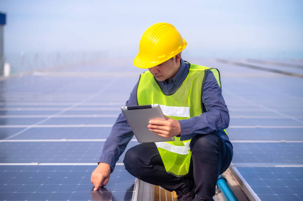 istock Engineer Hand checking solar power solar cell energy on rooftop of factory 1443567191