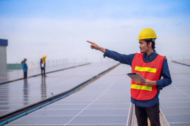istock Asian Engineer standing on rooftop factory and checking solar power solar cell energy by tablet technology. 1443567365