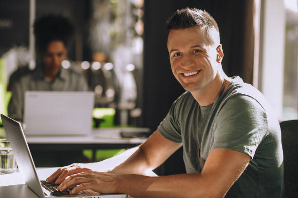 istock Cheerful young man posing for the camera in his workplace 1443570205