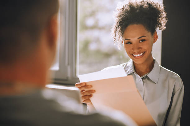 istock Pleased young female boss with documents looking ahead 1443570295