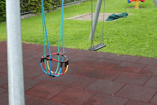 an empty swing on a playground